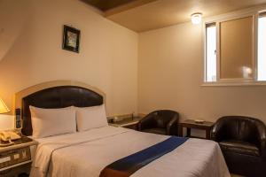 Ein Bett oder Betten in einem Zimmer der Unterkunft 真正好旅店 Good Hotel