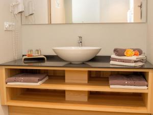 a bathroom counter with a sink and a mirror at Brauerei_Gasthof Pfister in Eggolsheim +47 photos