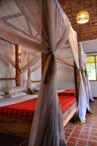 A bed or beds in a room at Honey Badger Lodge