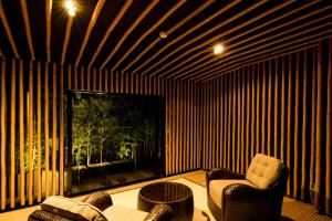 a living room with two chairs and a large window at Kinnotake Sengokuhara(Adult Only) in Hakone