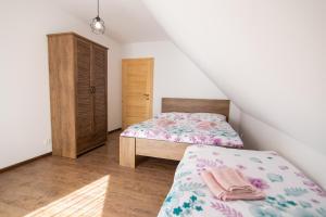 a small bedroom with two beds and a closet at Chata Zazrivka in Biela