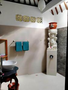 a bathroom with a sink and a counter with towels at Puri Mas Boutique Resort & Spa in Senggigi