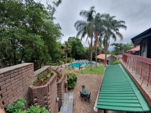 a view of a swimming pool from a house at The Palms Guesthouse in Nelspruit