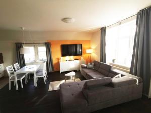 a living room with a couch and a table at Apartments Villa-Ratskopf Wernigerode in Wernigerode