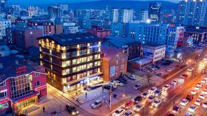 a city at night with cars parked on a street at Nomado Boutique Hotel in Ulaanbaatar