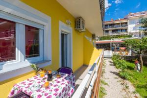 a table on the side of a yellow building at LUKA in Crikvenica