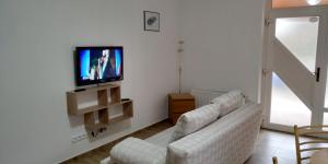 a living room with a couch and a flat screen tv at Ubytování Na Vyhlídce 143 in Benátky nad Jizerou