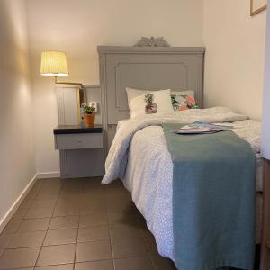 a bedroom with a bed with a gray headboard at IGMA Lodge in Borlänge +43 photos