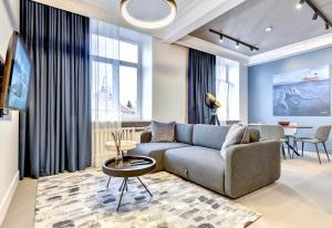 a living room with a couch and a table at Vilnius Apartments & Suites - Town Hall in Vilnius