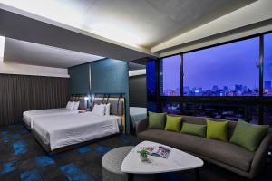 Postel nebo postele na pokoji v ubytování Kung Shang Design Hotel