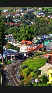 a town on a hill with a winding road at Skylarc Inn in Ooty
