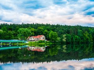 a house sitting on the shore of a lake at Przystanek Tleń in Tleń
