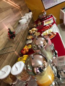 a buffet line with many different types of food at Shafira Hotel in Limeira