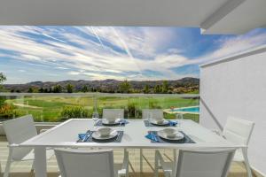 a white dining table and chairs on a balcony at Apartment front Line La Cala Golf Resort in La Cala de Mijas