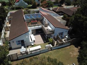 an aerial view of a house with a roof at The Green Palm Cottage in Plettenberg Bay
