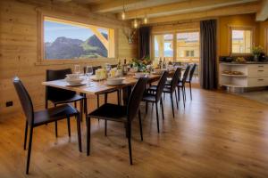 a dining room with a long table and chairs at Chalet Marinaka - OVO Network in Manigod