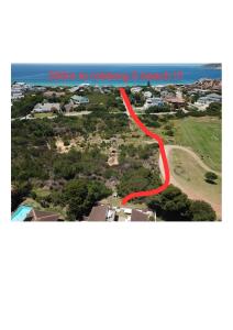 an aerial view of a house with a red road at The Green Palm Cottage in Plettenberg Bay