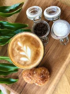 a cup of coffee and a pastry on a wooden table at Origin Uluwatu in Uluwatu
