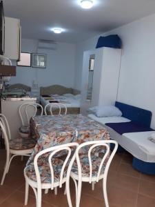 a room with two beds and a table and chairs at Apartments Jovanic with 2 bedrooms in Sutomore