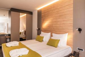 a hotel room with a bed with towels on it at Hotel Olea in Novalja