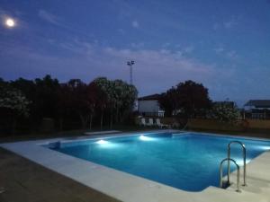 an empty swimming pool at night at Hotel La Barca in Lepe