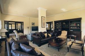 a living room with leather couches and a table at Altinkaya Holiday Resort in Kyrenia