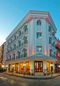 a large white building on a city street at The Magnaura Palace Hotel in Istanbul