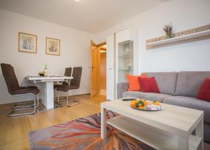 a living room with a couch and a table at Ferienwohnung Little Home in Winterberg-Neuastenberg in Winterberg