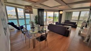 a living room with a glass table and a couch at Apartment Iva in Omiš