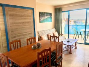 a living room with a wooden table and a couch at BENIDORM CENTER KENNEDY APARTMENT in Benidorm
