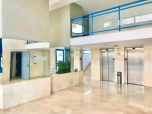 an empty lobby with elevators in a building at BENIDORM CENTER KENNEDY APARTMENT in Benidorm