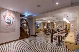 a restaurant with tables and chairs in a room at Pestana Churchill Bay in Câmara de Lobos