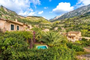 a villa with a swimming pool in the mountains at VILLA CIRCE in Fornalutx