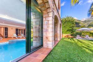 an external view of a house with a swimming pool at VILLA CIRCE in Fornalutx