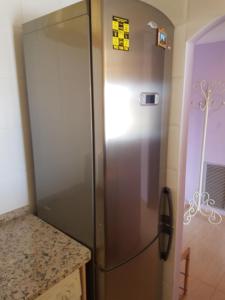 a stainless steel refrigerator in a kitchen next to a counter at Magnífico apartamento junto al canal principal. in Empuriabrava