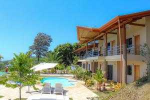 a villa with a swimming pool and a resort at Vista Villas in Ojochal