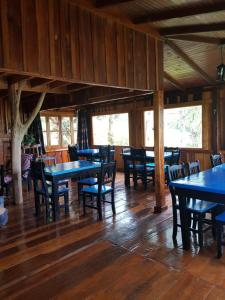 a dining room with blue tables and chairs at Aires del Monte in El Soberbio