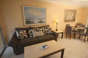 a living room with a couch and a table at 1/1 bed&bath condos 5 min drive to Siesta in Sarasota