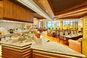 a restaurant with tables and chairs in a room at Seven Seas Hotel in New Delhi
