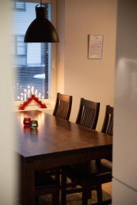 a dining room table with chairs and a black light at Apartment Loimu C75 in Rovaniemi