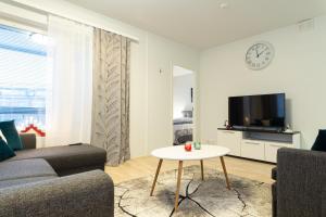 a living room with a couch and a table at Apartment Loimu C75 in Rovaniemi