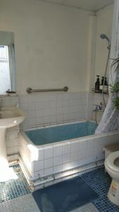un bagno con vasca, lavandino e WC di ZYIN Homestay a Kaohsiung