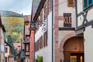 a building with a clock on the side of it at Hotel KLE, BW Signature Collection in Kaysersberg