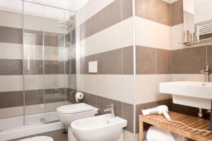 a bathroom with a toilet and a sink at Palazzo Talenti 1907 in Trieste