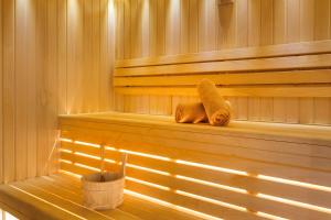 a sauna with two towels sitting on the shelves at Hotel KLE, BW Signature Collection in Kaysersberg