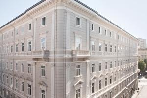 a white building with balconies on the side of it at Palazzo Talenti 1907 in Trieste