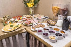 a table with many plates of food on it at Kazimierz Secret in Kraków