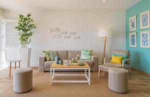 a living room with a couch and a coffee table at H10 Playa Esmeralda - Adults Only in Costa Calma