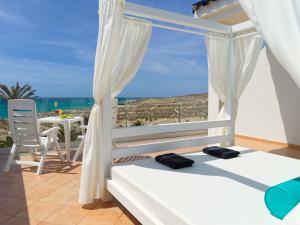 a bedroom with a view of the ocean at H10 Playa Esmeralda - Adults Only in Costa Calma
