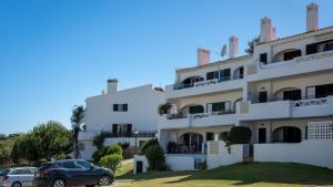 a building with cars parked in front of it at Sienna in Vale do Lobo